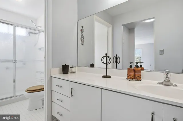 a bathroom with a sink toilet and shower