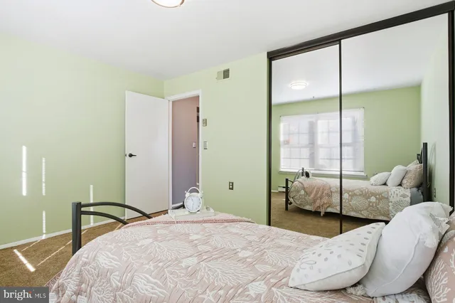 a bedroom with a bed and large window