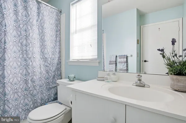 a bathroom with a sink toilet and mirror
