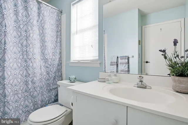 a bathroom with a sink toilet and mirror