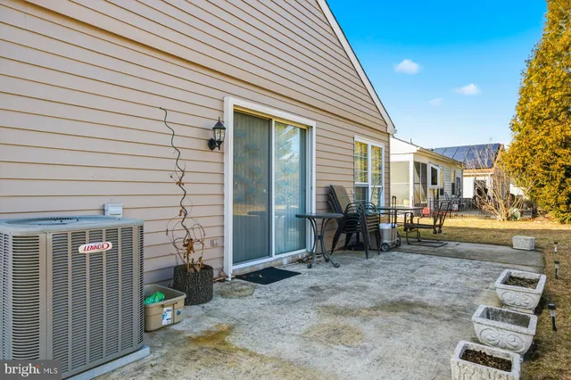 a backyard of a house with barbeque oven table and chairs