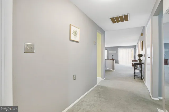 a view of a room with cabinet and a hallway