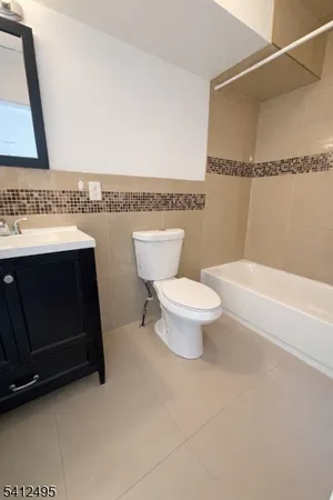 a bathroom with a toilet a sink and bathtub
