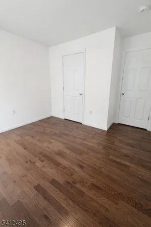 a view of room with wooden floor