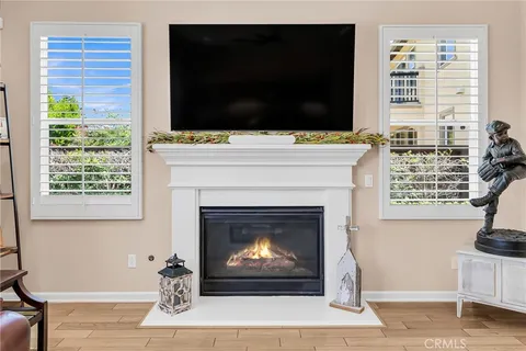 a living room with a fireplace and a flat screen tv