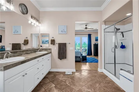 a spacious bathroom with a double vanity sink shower and mirror
