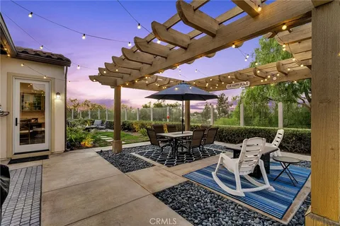 a view of a patio with a dining table and chairs
