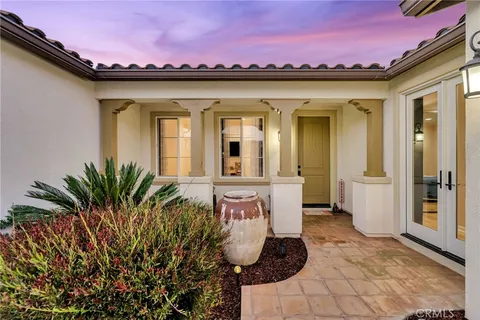 a front view of a house with outdoor seating and shower