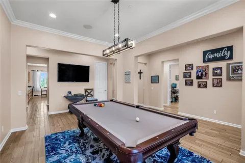 a room with furniture pool table and flat screen tv
