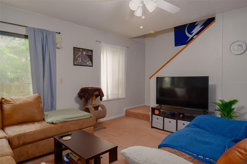 2300 Southwest 43rd Street, Unit K5 Gainesville, FL 32607 - Photo 12 of 18 a living room with furniture and a flat screen tv