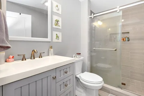 a bathroom with a sink toilet and shower