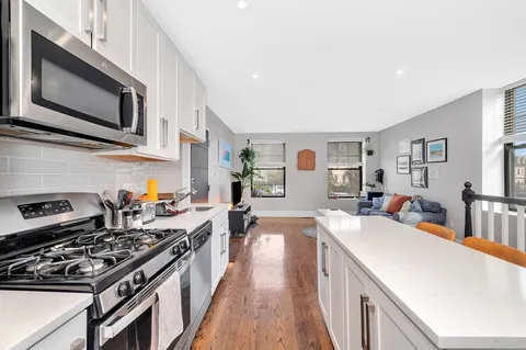 a kitchen with stainless steel appliances a sink dishwasher stove microwave and cabinets