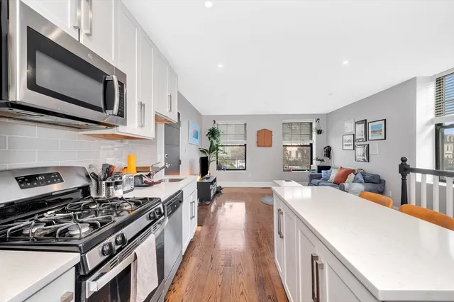a kitchen with stainless steel appliances a sink dishwasher stove microwave and cabinets
