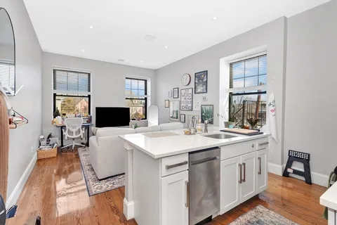 a kitchen with a sink stove and cabinets