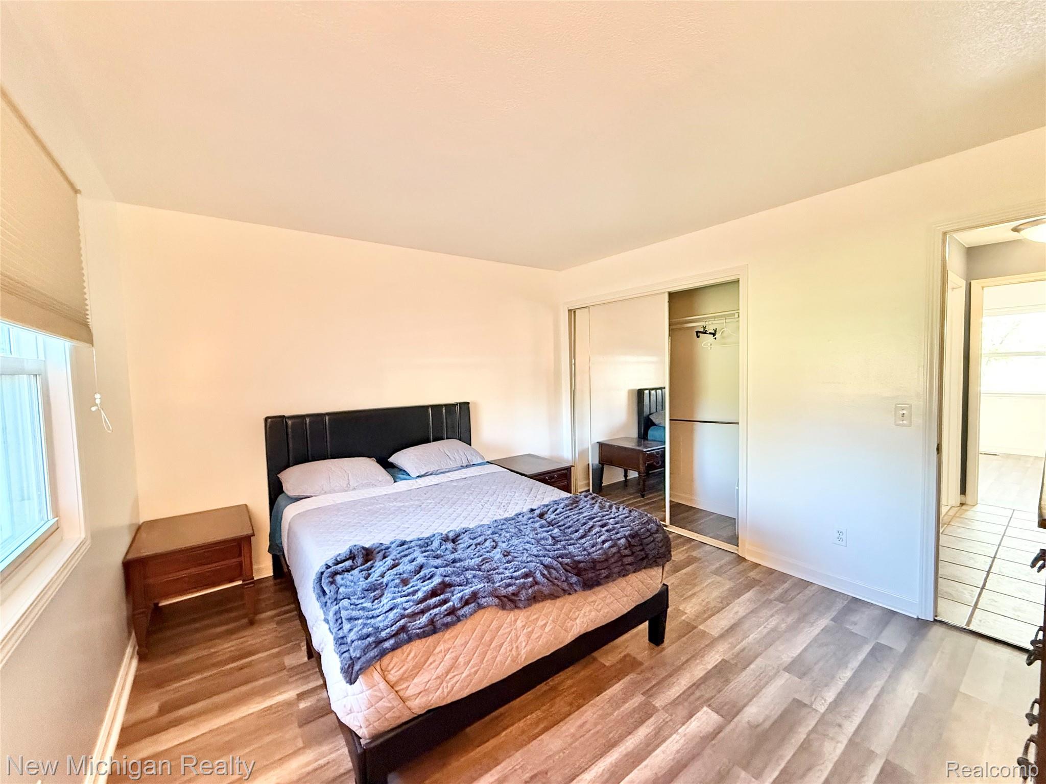 5288 Torrey Road Flint, MI 48507 - Photo 14 of 41 Bedroom with light wood-type flooring and a closet