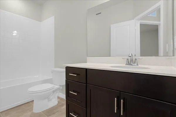a bathroom with a sink toilet a mirror and shower