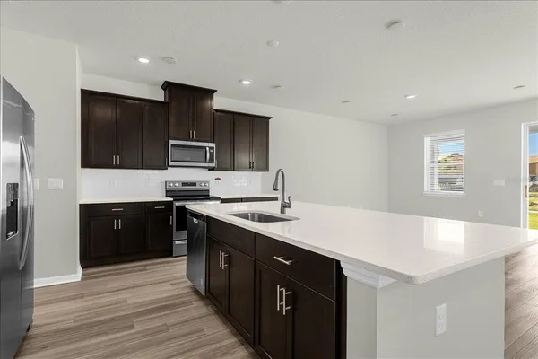 a kitchen with a sink stove and refrigerator