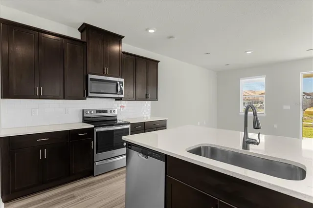 a kitchen with a sink and stainless steel appliances