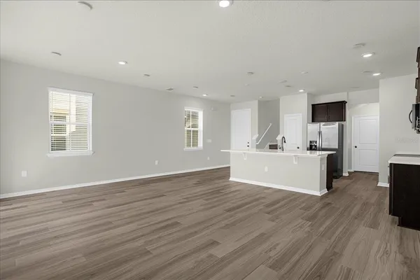 a view of kitchen with wooden floor and window