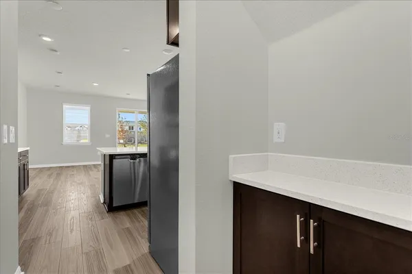 a view of kitchen with windows and refrigerator