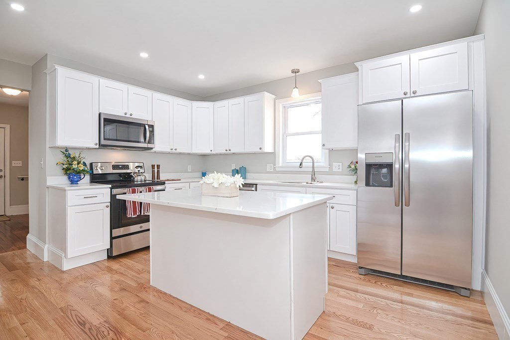 14 Allen Road Norwood, MA 02062 - Photo 4 of 36 a kitchen with kitchen island granite countertop a sink cabinets and stainless steel appliances