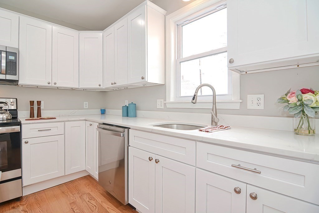 14 Allen Road Norwood, MA 02062 - Photo 7 of 36 a kitchen with granite countertop white cabinets and white appliances