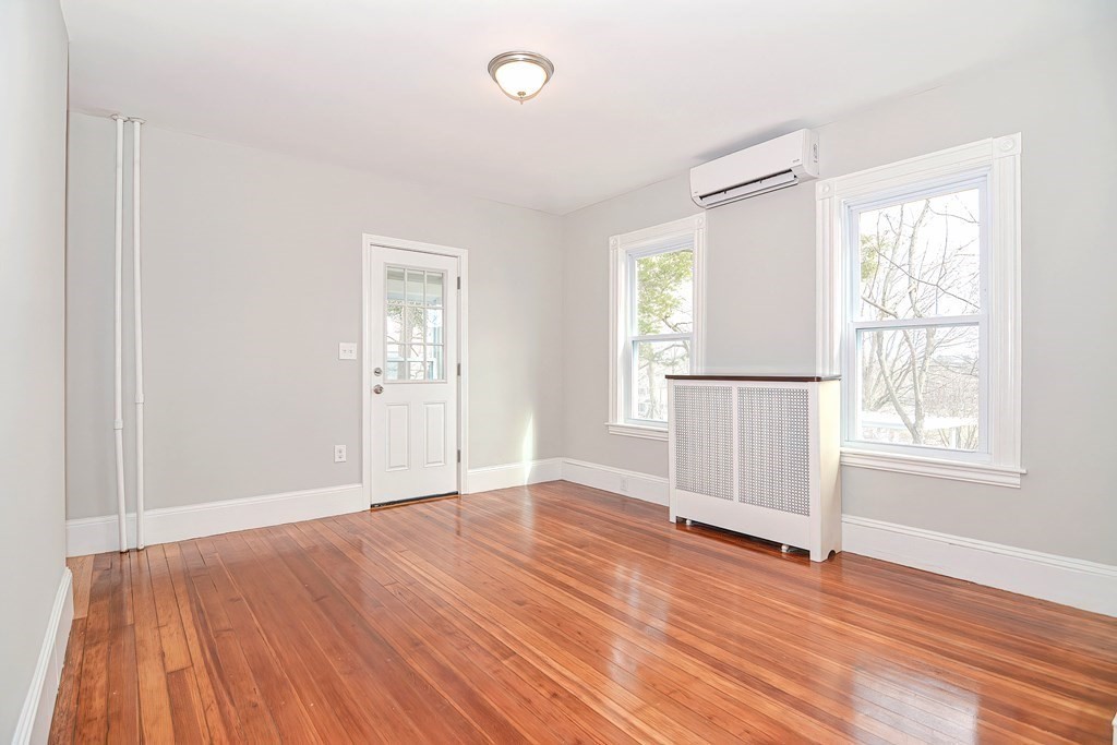 14 Allen Road Norwood, MA 02062 - Photo 10 of 36 an empty room with wooden floor and windows
