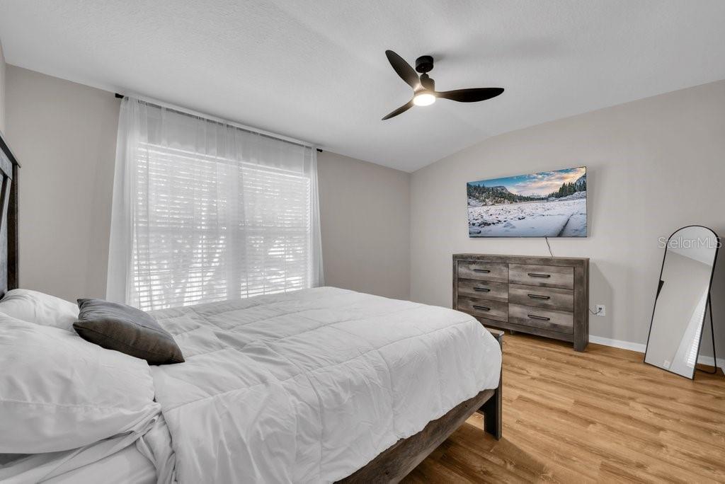 15855 Fishhawk View Drive Lithia, FL 33547 - Photo 17 of 31 a bedroom with a bed a dresser and a large window