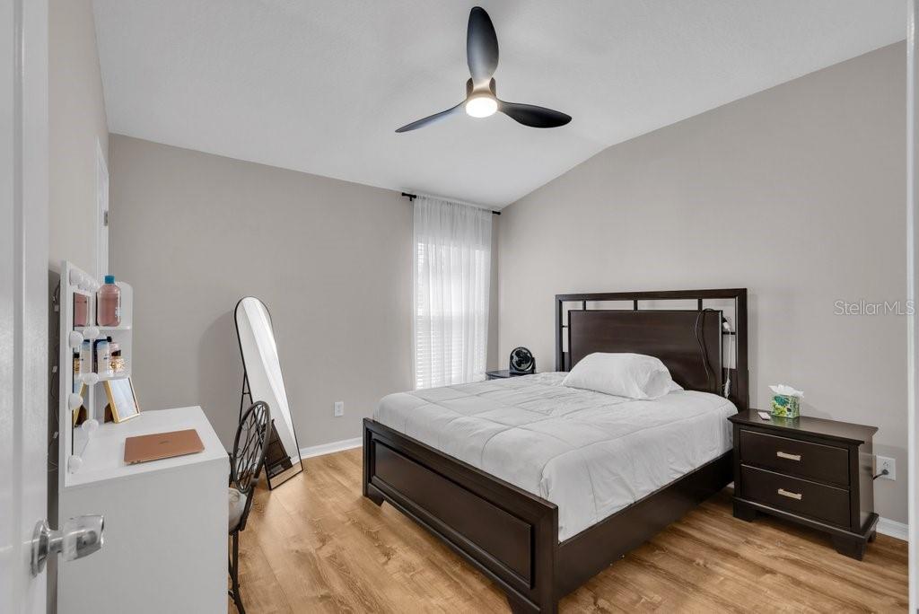 15855 Fishhawk View Drive Lithia, FL 33547 - Photo 20 of 31 a bedroom with a bed and a chandelier