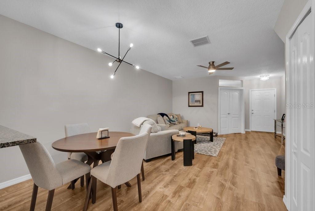 15855 Fishhawk View Drive Lithia, FL 33547 - Photo 7 of 31 a living room with furniture and a chandelier