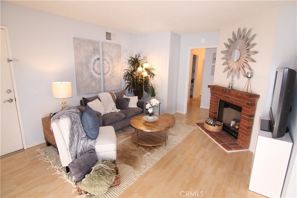 157 South Poplar Avenue, Unit 23 Brea, CA 92821 - Photo 1 of 1 a living room with furniture and a fireplace