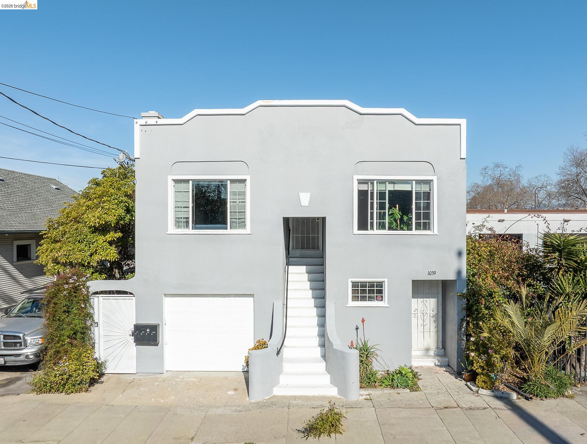 Mediterranean / spanish home with stucco siding, an attached garage, and concrete driveway