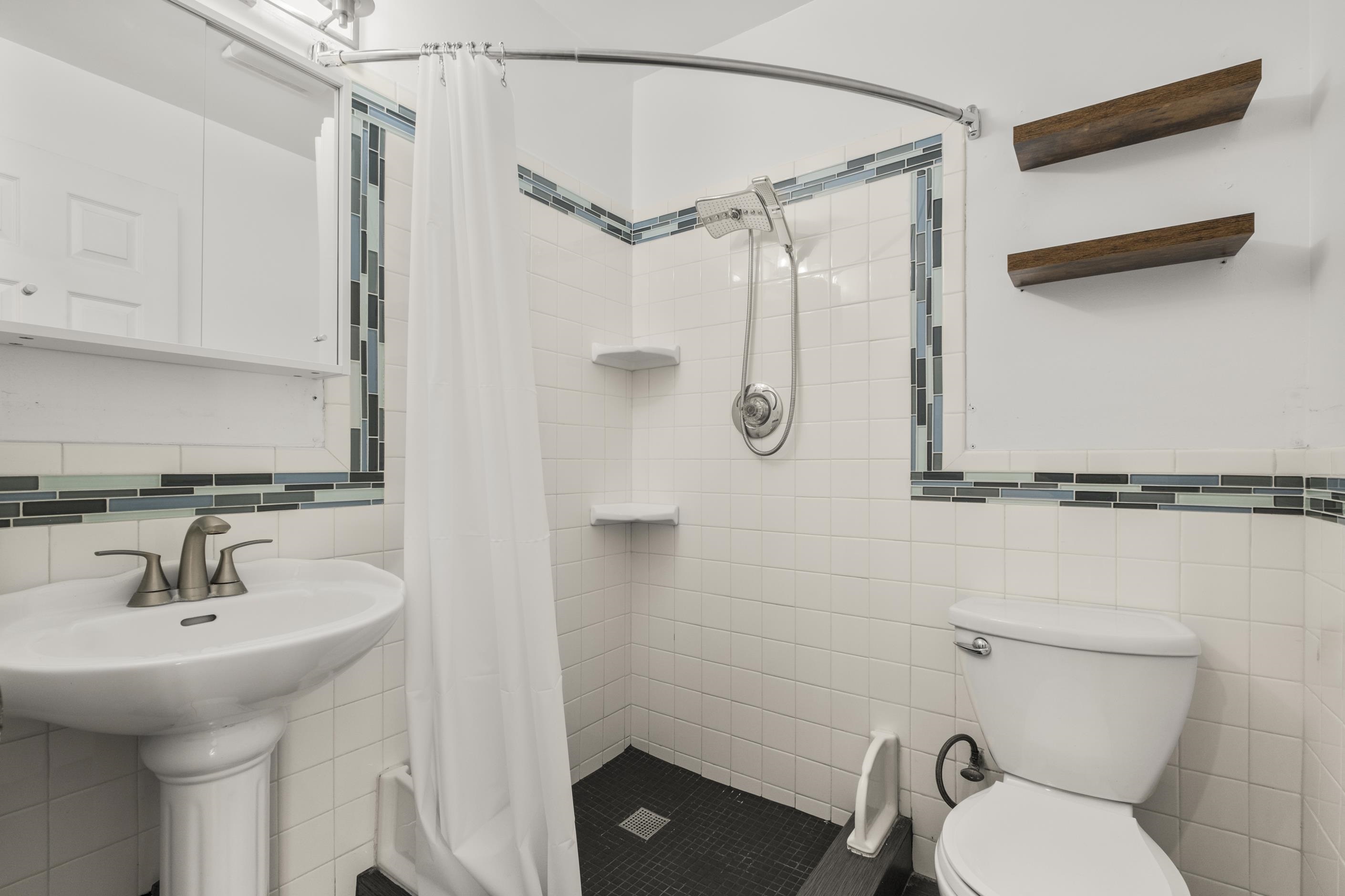 1039 Channing Way Berkeley, CA 94710 - Photo 11 of 25 Bathroom with tile walls, a shower stall, and a wainscoted wall