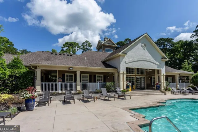 a view of a house with backyard sitting area and garden