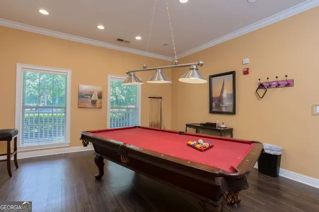 a patio with a table and chairs under an umbrella with a fire pit