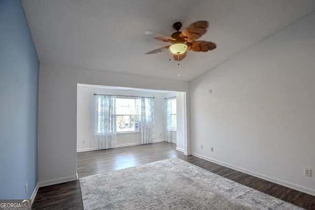 a view of livingroom with kitchen and dining table