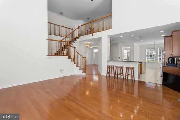 a view of a hallway with wooden floor and dining room