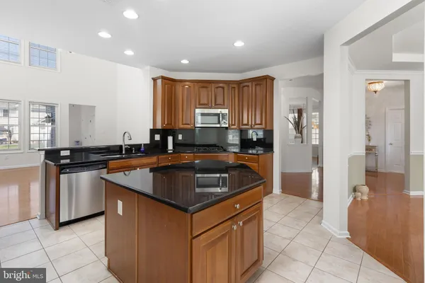 a kitchen with granite countertop a sink and a stove top oven