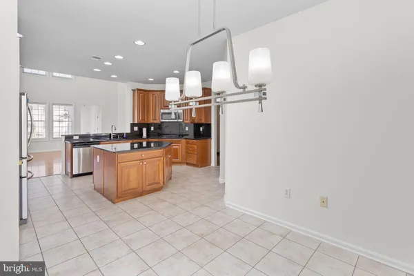 a kitchen with a sink window and stainless steel appliances