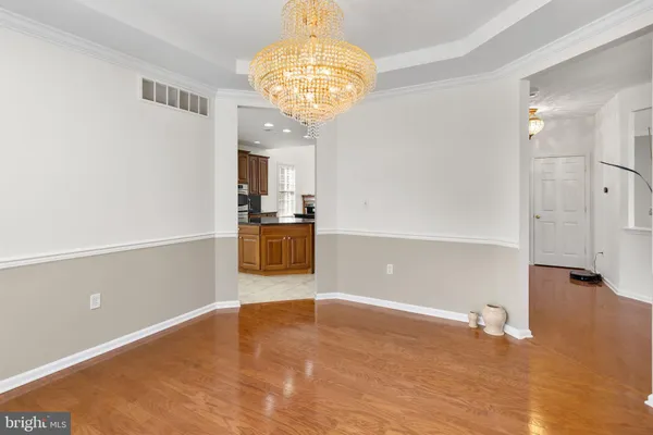 a view of a kitchen with a dishwasher cabinets and a chandelier