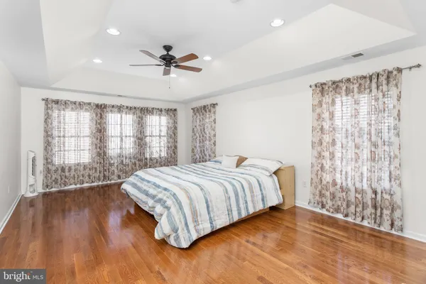 a bedroom with a large bed and a large window
