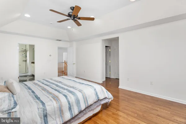 a bedroom with a bed and a ceiling fan
