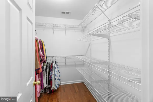 a view of walk in closet with clothes