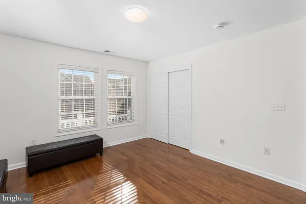 a view of a room with wooden floor and a window