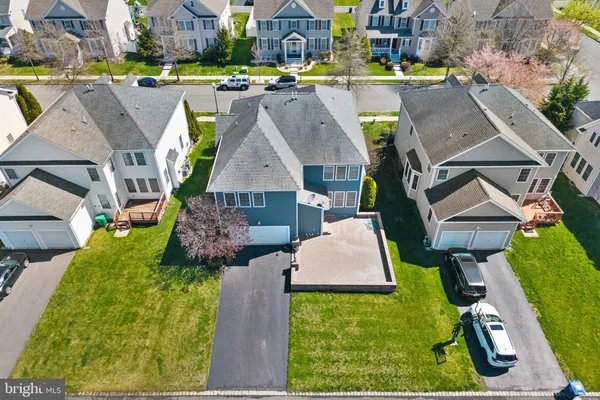 an aerial view of a house with swimming pool and a yard