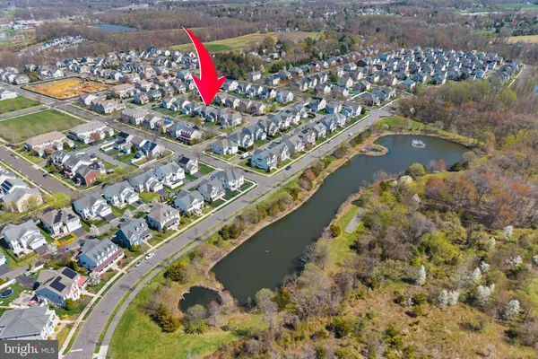 an aerial view of a houses with a swimming pool