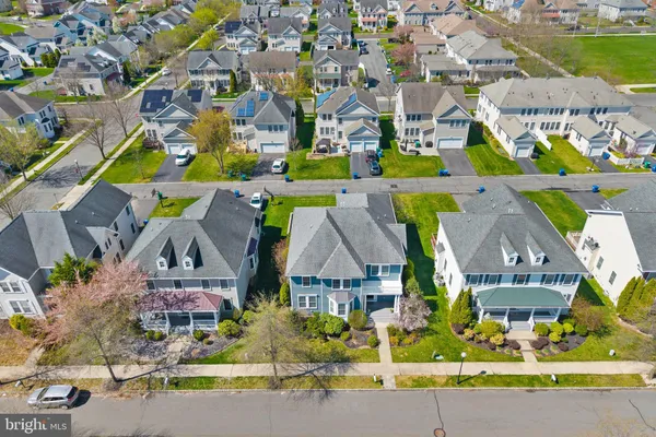 an aerial view of multiple houses with a street