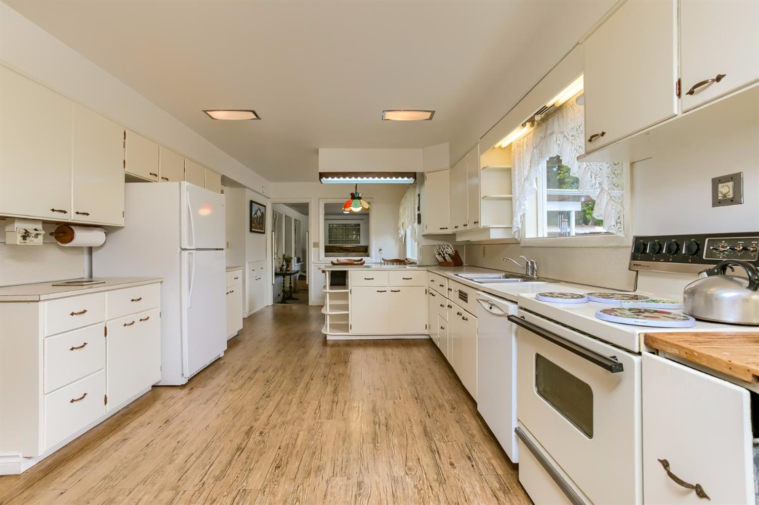 445 Cow Creek Road Riddle, OR 97469 - Photo 11 of 35 a large kitchen with a lot of counter space and wooden floor