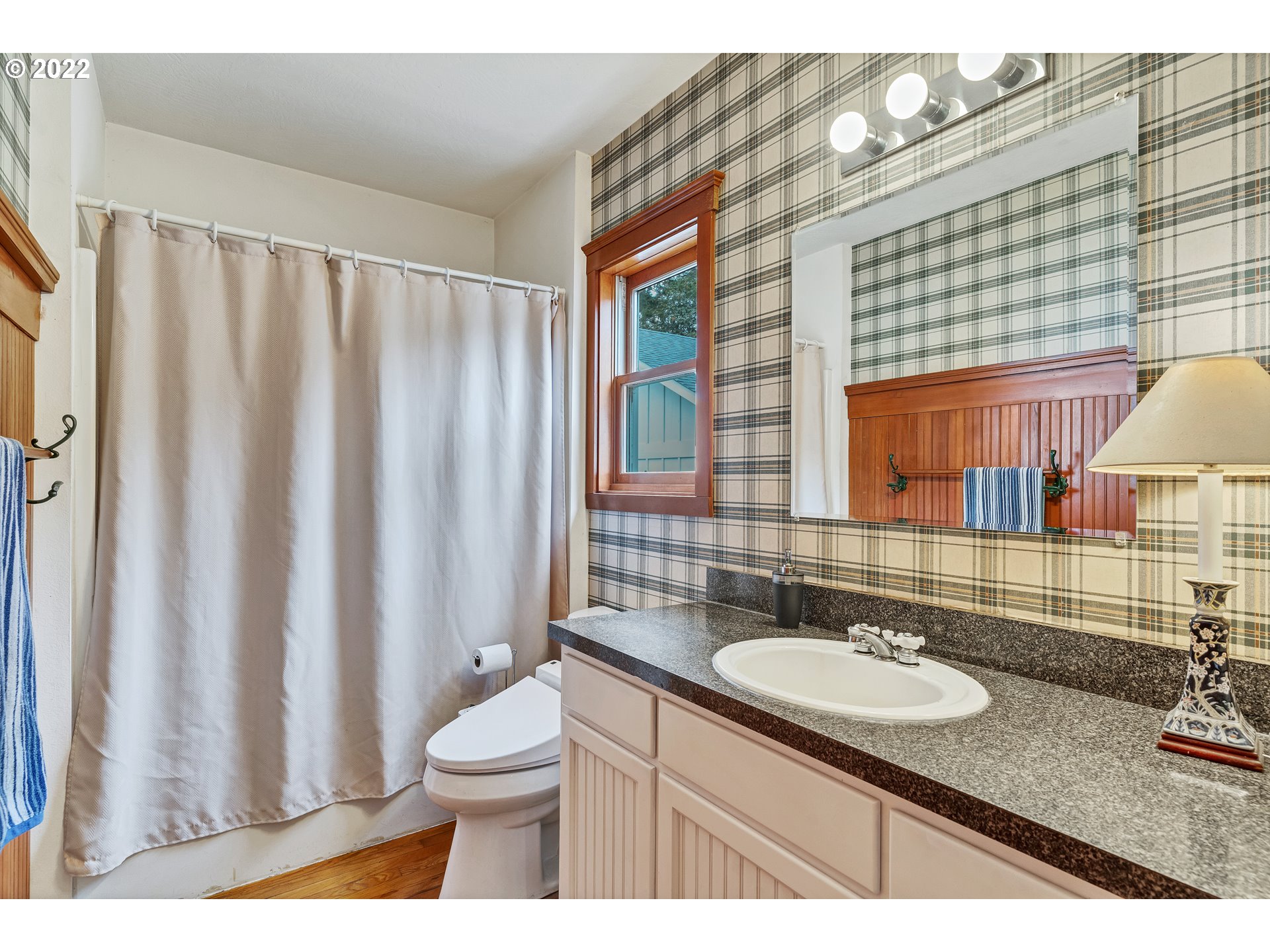 86835 R.R. Baker Road Springfield, OR 97478 - Photo 18 of 32 a bathroom with a granite countertop sink toilet a mirror and shower curtain