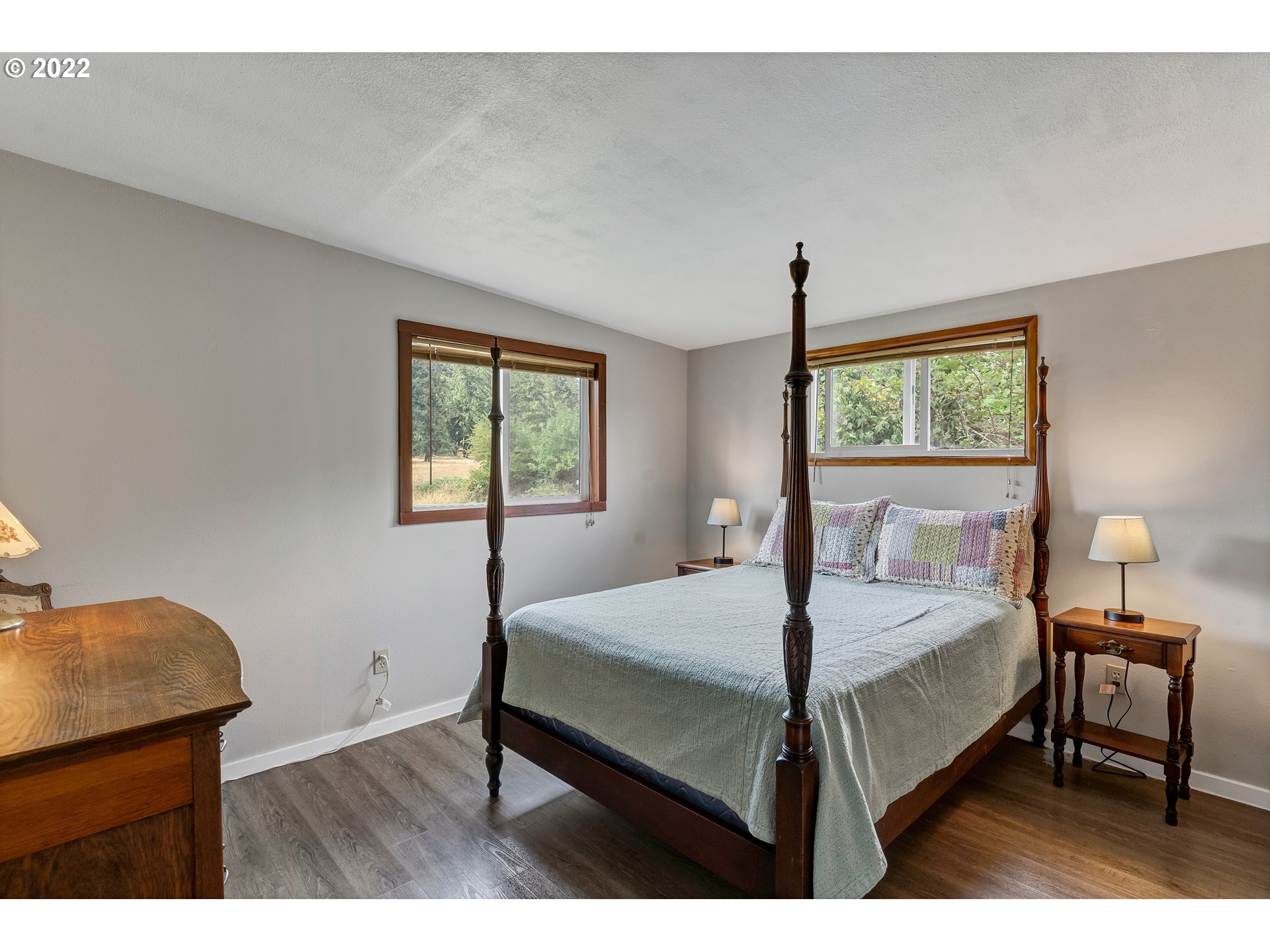 86835 R.R. Baker Road Springfield, OR 97478 - Photo 27 of 32 a bedroom with a bed a chandelier and a window